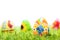 Colorful hand painted Easter eggs in grass. Spring theme, white copy-space