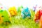 Colorful hand painted Easter eggs in grass. Spring theme, white copy-space