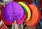 Colorful handmade natural raffia fans displayed in the shop at flea market in Thailand