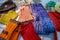 Colorful handmade wool beanies, scarves, and tablecloths at the flea market