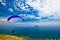 Colorful hang glider in sky