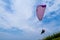 Colorful hang glider in sky