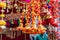 Colorful hanging Indian decorations for sale in colors of yellow, orange and red in Old Delhi market in India