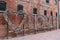 Colorful hanging locks on a love fence with a red wall in background in Toronto in the Distillery District in Canada