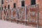 Colorful hanging locks on a love fence with a red wall in background in Toronto in the Distillery District in Canada