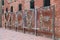 Colorful hanging locks on a love fence with a red wall in background in Toronto in the Distillery District in Canada