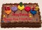 Colorful Happy Birthday chocolate cake with age candles