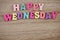 Colorful Happy Wednesday alphabet letters on wooden background