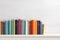 colorful hardcover books on a white shelf