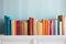 colorful hardcover books on a white shelf