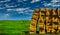 Colorful hay bales piled up on green field