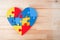 A colorful heart made of symbolic autism puzzle pieces.