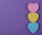 Colorful Hearts. Three Sweetheart Candy over purple background