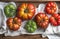 Colorful Heirloom tomatoes in rustic wooden tray