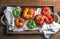 Colorful Heirloom tomatoes in rustic wooden tray