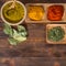 Colorful herbs,spices and aromatic ingredients on wooden table.