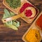 Colorful herbs,spices and aromatic ingredients on wooden table.