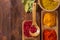 Colorful herbs,spices and aromatic ingredients on wooden table.