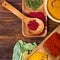 Colorful herbs,spices and aromatic ingredients on wooden table.