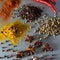 Colorful herbs and spices for cooking dishes. Indian and Asian spices On grey stone background closeup