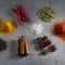 Colorful herbs and spices for cooking dishes. Indian and Asian spices On grey stone background closeup