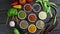 Colorful herbs and spices for cooking. Indian spices. On a black background. Top view