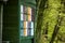 Colorful honey beekeeping boxes in the green forest