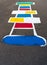 Colorful hopscotch game painted on black asphalt