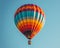 A colorful hot air balloon floating against a clear blue sky