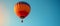 A colorful hot air balloon floating against a clear blue sky