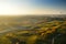 Colorful hot air balloon flying over fields surrounding Vilnius city on sunny autumn evening.