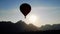 Colorful hot-air balloon raising just in time to explore beautiful sunset over Vang Vieng in Laos, Southeast Asia.