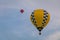 Colorful hot air balloons float through the sky at dusk at Warren County Farmer`s Fair, Harmony, New Jersey, on 8/1/17