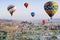 Colorful hot air balloons flying over Cavusin at Cappadocia