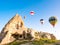 Colorful hot air balloons flying over rock landscape at Cappadocia Turkey