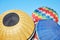Colorful hot air balloons inflating on ground, blue sky