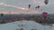 Colorful Hot Air Balloons over the snowy fairy chimneys at sunrise in Cappadocia