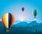 Colorful hot air baloons flying over mountains.