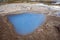 Colorful hot water pool in Iceland next to Strokkur, the biggest geyser in Iceland