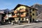 Colorful hotel, chalet style, in the popular ski town of Pinzolo, Dolomites, Italy, Europe.