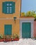 Colorful house exterior green door and windows with flowerpots, Plaka old neighborhood, Athens Greece