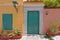 Colorful house exterior green door and windows with flowerpots, Plaka old neighborhood, Athens Greece