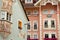 Colorful house facades decorated with art paintings in the historic center of Ortisei