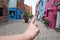 Colorful houses in Burano, Italy and boy. Painted houses decorated with flowers. Follow me and I shall lead the way.