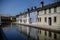 Colorful houses reflected in the waters of the canal in Comacchio, Emilia Romagna, Italy.