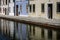 Colorful houses reflected in the waters of the canal in Comacchio, Emilia Romagna, Italy.