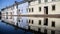 Colorful houses reflected in the waters of the canal in Comacchio, Emilia Romagna, Italy.