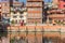 Colorful houses reflecting in the pond at the Pimbahal Pokhari Krishna temple in Patan