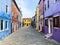 Colorful houses on a small traditional square at Burano island, Venice