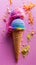 Colorful ice cream cone with pink and blue scoops on vibrant pink background, surrounded by scattered crumbs